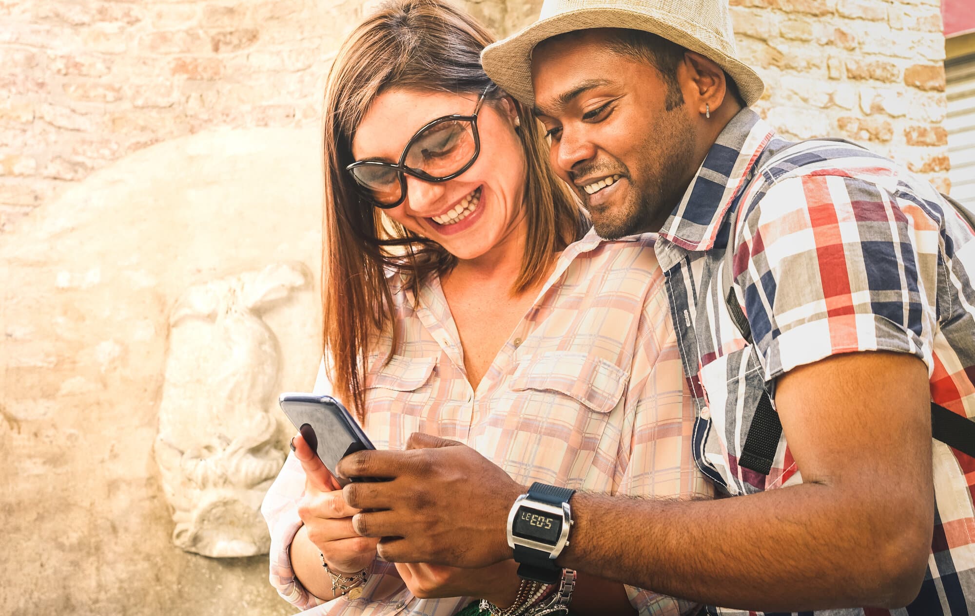 multiracial couple using mobile smart phone at old town trip f