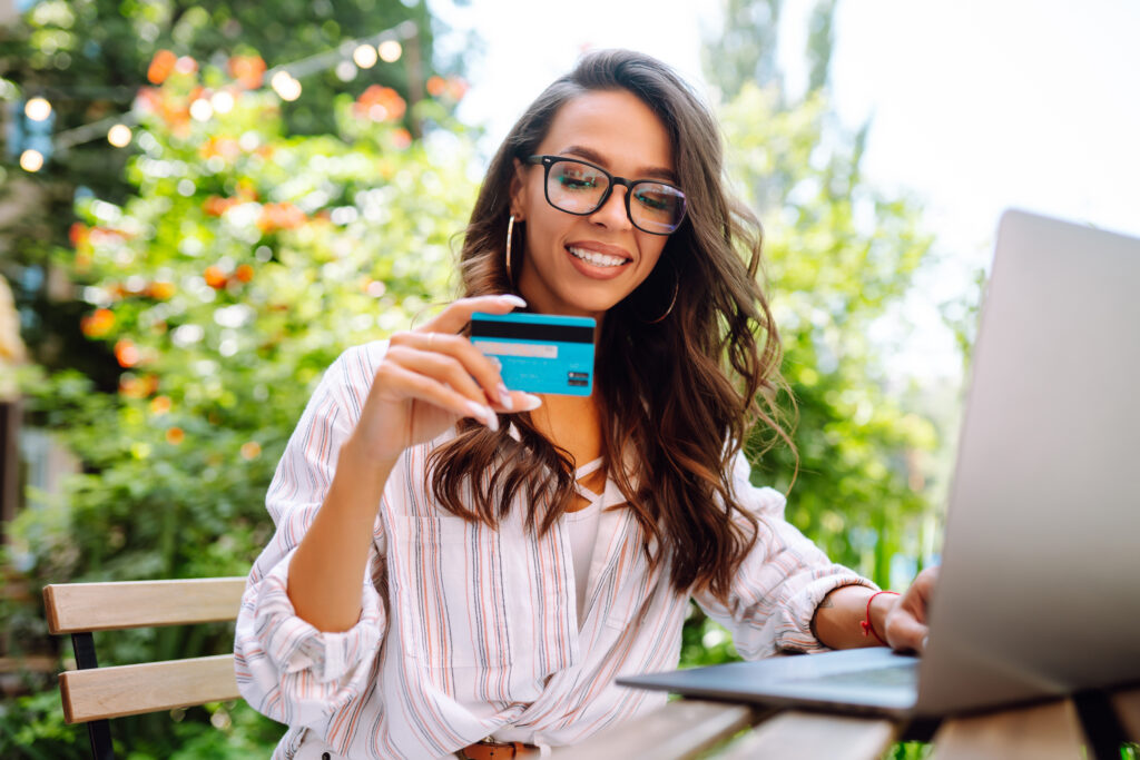 Young Woman Planning Vacation Online with Credit Card