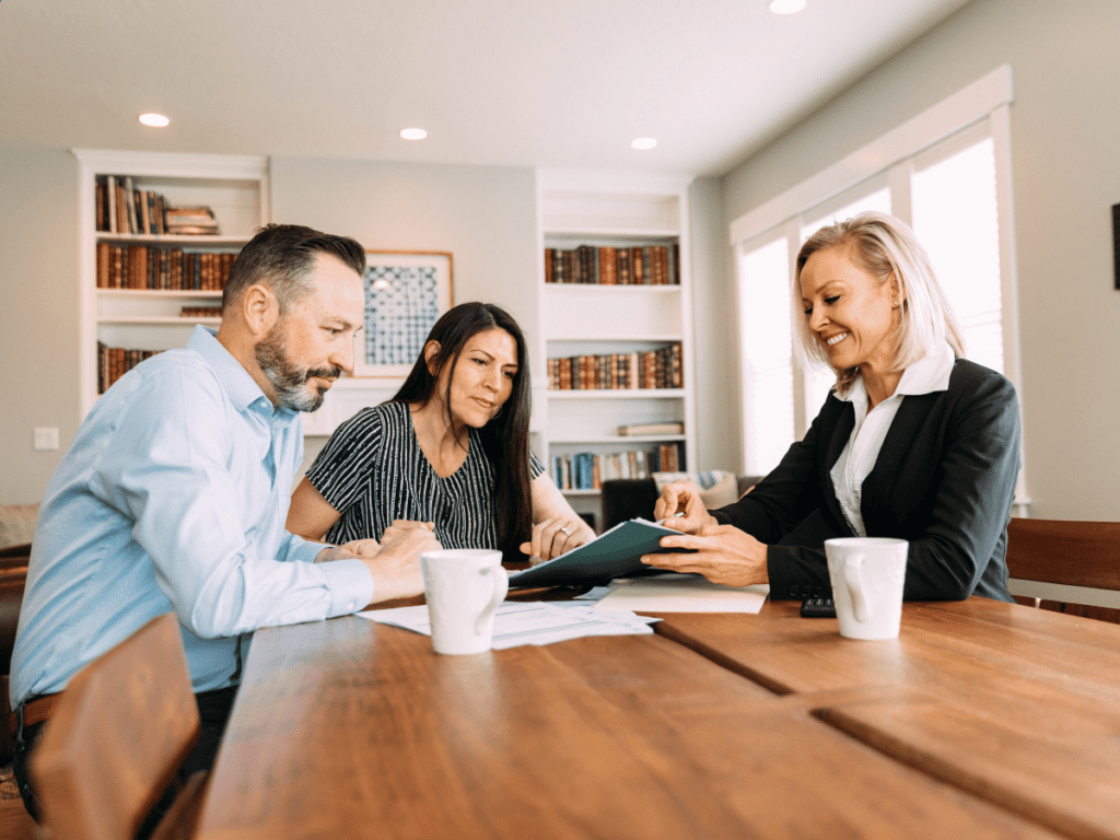 couple sitting with financial advisor examining their security and future