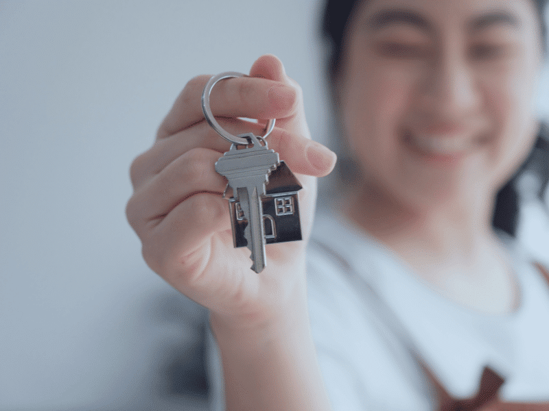 woman who just purchased a new home with her new keys